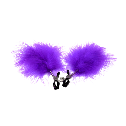 Purple fluffy feather attached to nipple clips on a white background